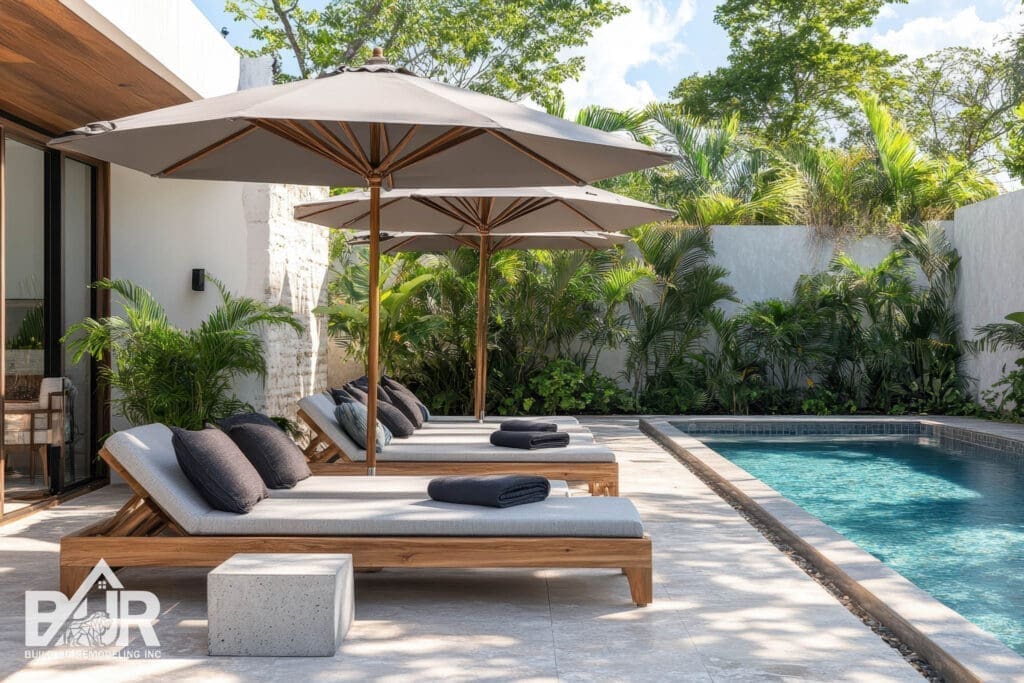 Contemporary poolside lounge area with a concrete umbrella stand and stylish gray pavers inspired by eco friendly Tulum Mexico