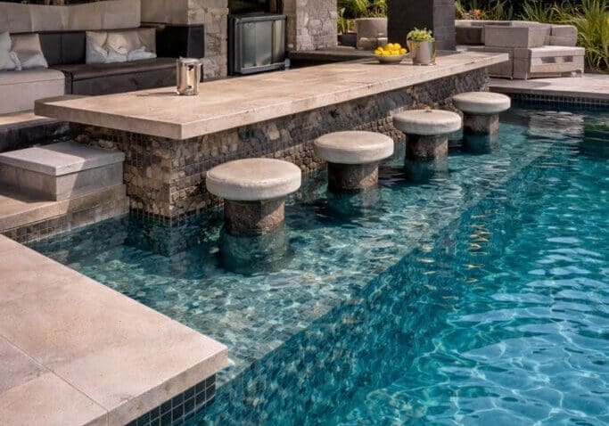 Luxury poolside bar with stone stools.