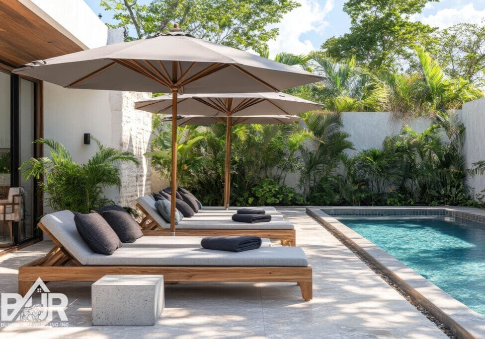 Contemporary poolside lounge area with a concrete umbrella stand and stylish gray pavers inspired by eco friendly Tulum Mexico